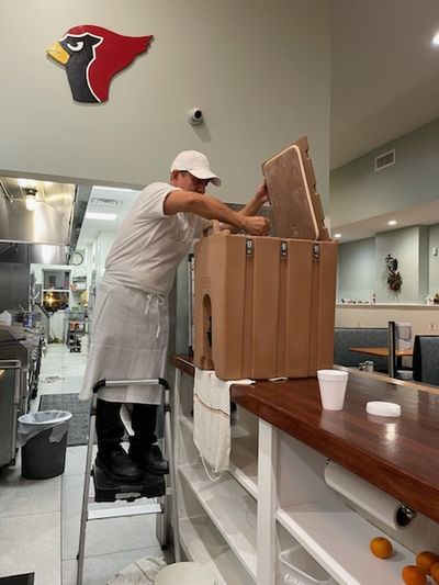 Manny readies the kitchen gear to hold all that hot chocolate for the strollers.